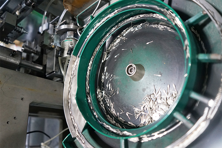 Load bearing wheel and shaft assembly machine